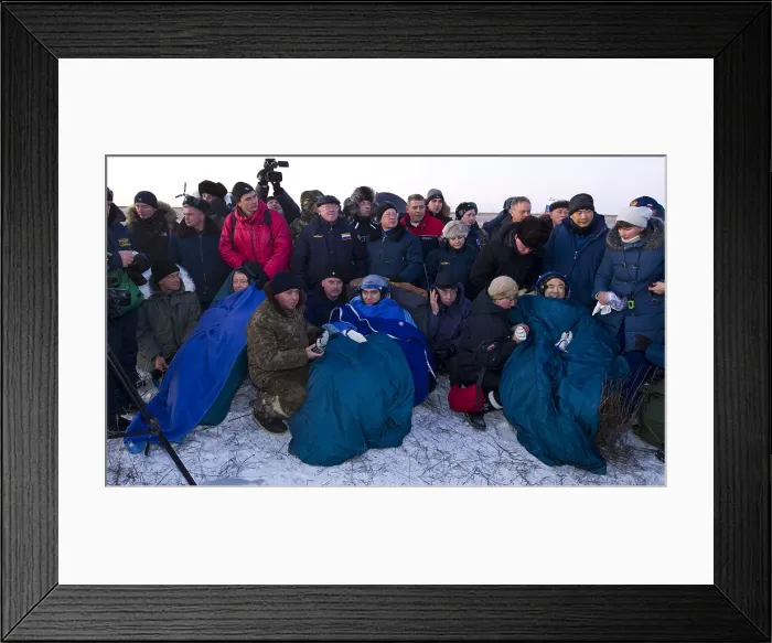 Framed Print : After five months in space, space travelers recline in chairs the Soyuz TMA-02M capsule after they landed in Kazakhstan