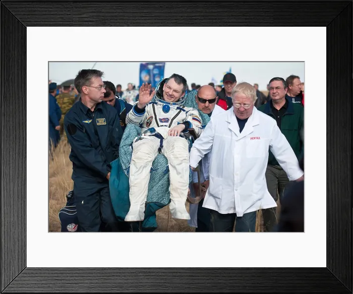 Framed Print : Cosmonaut Alexander Samokutyaev carried after returning from over five months aboard the International Space Station
