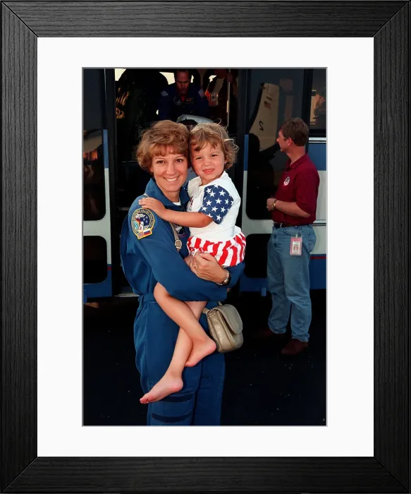 Framed Print : Commander Eileen Collins and her daughter, Bridget Youngs, following the completion of the Space Shuttle mission 95. July 28, 1999 Framed Print : Commander Eileen Collins and her daughter, Bridget Youngs, following the completion of the Space Shuttle mission 95. July 28, 1999