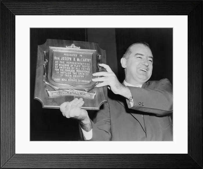 Framed Print : Wisconsin Senator Joseph McCarthy displays a plaque honoring him...for his fearless persistence in battling the enemies of their country