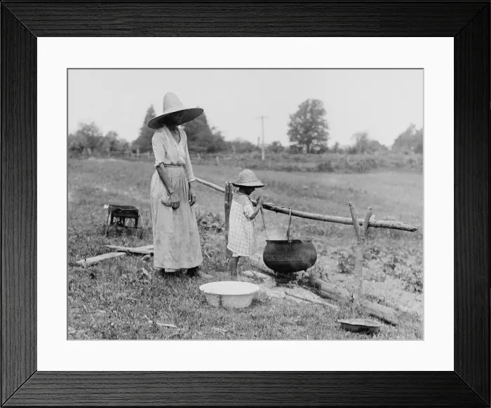 Framed Print : African American mother and daughter boiling water over an outside fire. Colonial Beach, Virginia, 1920. (BSLOC_2015_16_126)