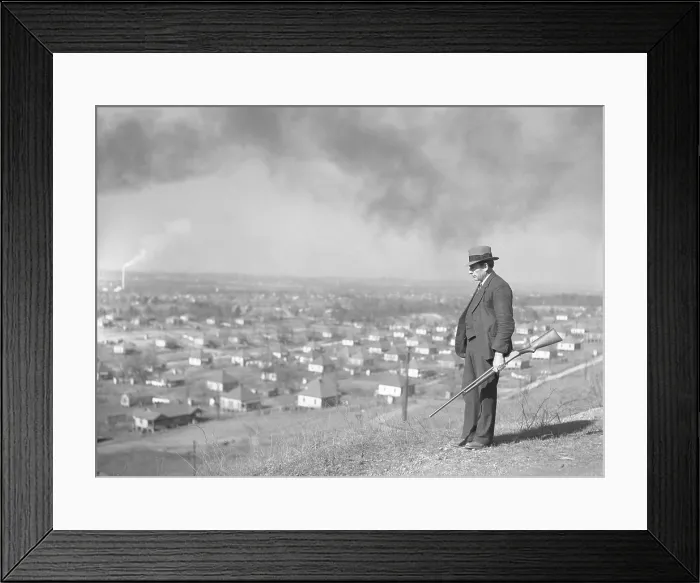 Framed Print : An armed private guard watches over a steel mining company town in Jefferson County, Alabama, in 1937. The New Deal supported labor organization which caused tension in the U.S