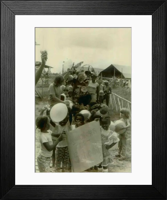 Framed Print : Children from the Jonestown Pre-School in a parade carrying a poster. People's Temple Agricultural Project. Jonestown, Guyana. Nov. 1978