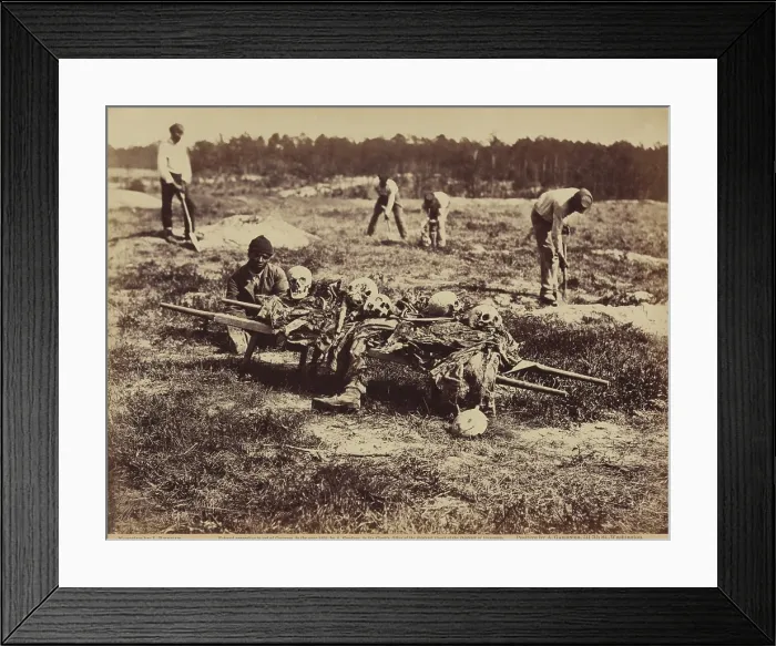 Framed Print : An African American soldier of a burial party on the battle-field of Cold Harbor seated next to a stretcher containing remains of Union soldiers who perished in the battles of