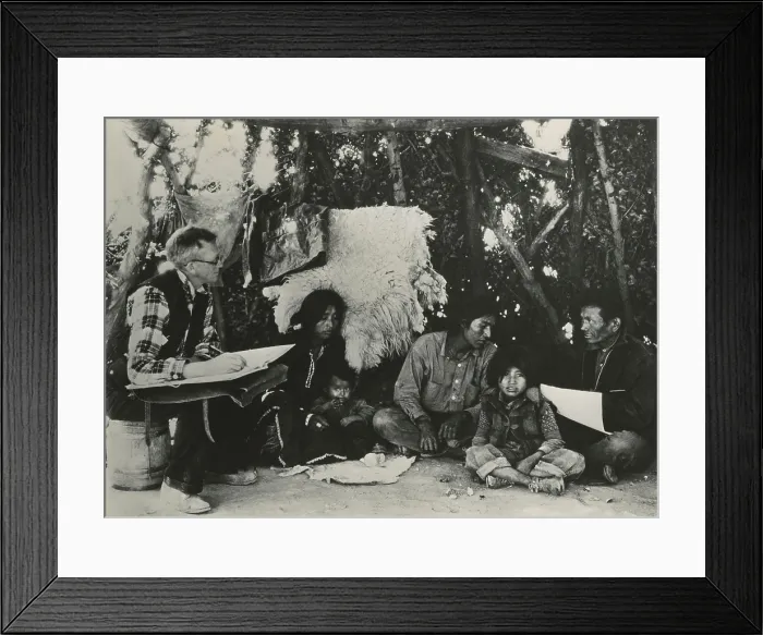 Framed Print : 1940 Census taker, seated on a barrel, interviewing a Navajo family. At right is an Indian interpreter to assist communication. (BSLOC_2013_9_5) Framed Print : 1940 Census taker, seated on a barrel, interviewing a Navajo family. At right is an Indian interpreter to assist communication. (BSLOC_2013_9_5)