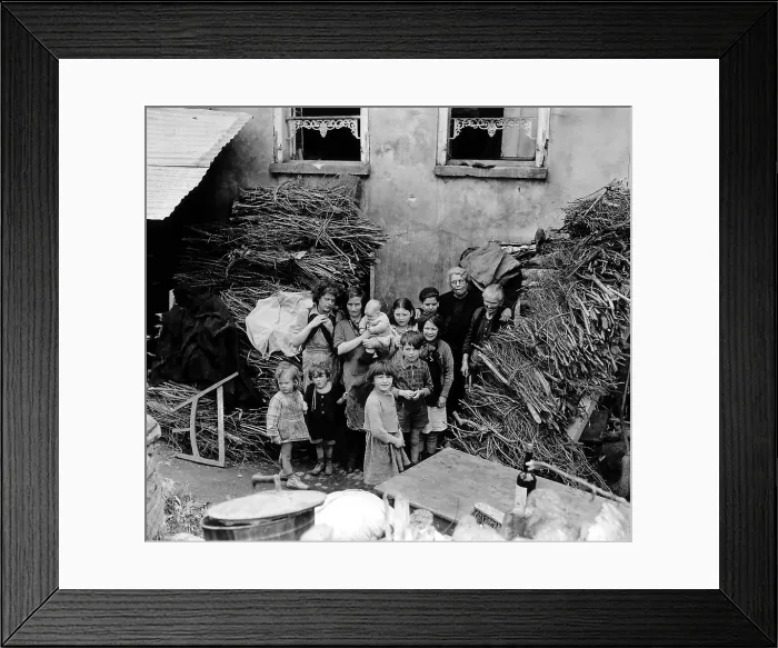 Framed Print : French family outside their home in Saint Lo, July 26, 1944. Bundles of wood cover shell holes and protected them from shrapnel. Normandy Campaign, France, World War 2