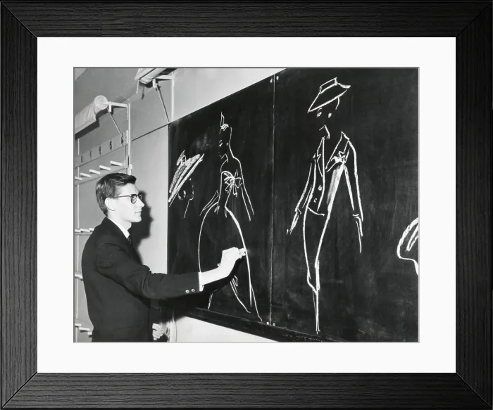 Framed Print : Yves Saint Laurent sketching designs for Christian Dior 1958 fashion line in Paris