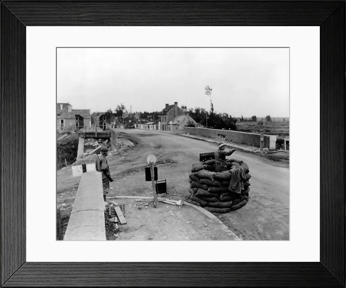 Framed Print : U.S. MP controls traffic on a bridge at Carentan, sheltered in a booth made ??with sandbags. July 5, 1944. Normandy Campaign, France, World War 2. (BSLOC_2014_2_104)