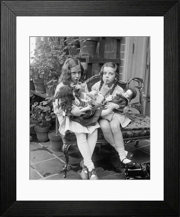 Framed Print : Two young girls with dolls, ca. 1920. They ask for quiet as they pretend their dolls are asleep. (BSLOC_2015_16_231) Framed Print : Two young girls with dolls, ca. 1920. They ask for quiet as they pretend their dolls are asleep. (BSLOC_2015_16_231)