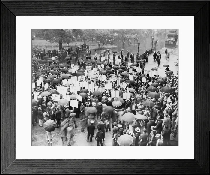 Framed Print : The Great Depression. A crowd of depositors protest in the rain at the Bank of United States after its failure. Signs demand bank stockholders be taxed to repay small depositors
