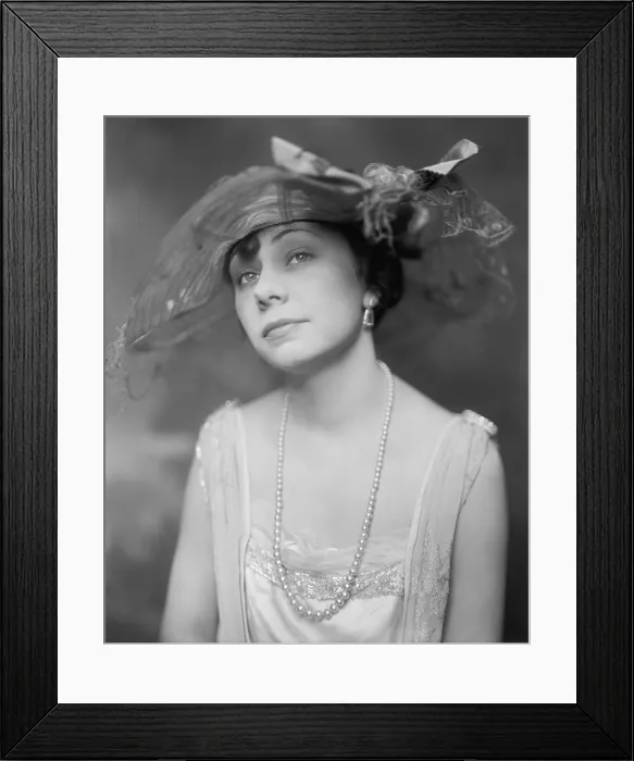 Framed Print : New York Socialite Miss Inez Thomas modeling a hat, long string of pearls, and evening gown. Ca. 1920. (BSLOC_2015_16_245)