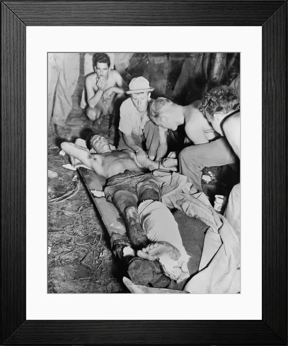 Framed Print : A wounded American soldier gets a blood transfusion in New Guinea jungle. The U.S. Army was fighting against the Japanese during World War 2. 1943-45. (BSLOC_2013-12_182) Framed Print : A wounded American soldier gets a blood transfusion in New Guinea jungle. The U.S. Army was fighting against the Japanese during World War 2. 1943-45. (BSLOC_2013-12_182)
