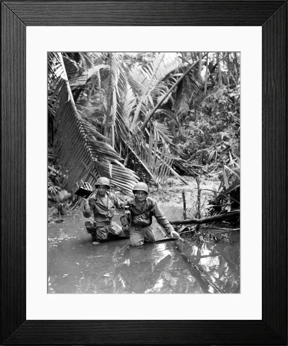 Framed Print : U.S. Army photographer, wading through a stream during an invasion at a beach in New Guinea