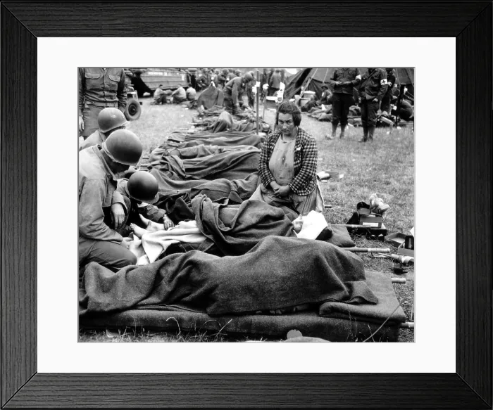 Framed Print : Three U.S. Army medics attend to a young girl's injury on Aug. 1, 1944, in Normandy. She was probably wounded during Operation Cobra, the U.S