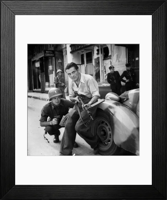 Framed Print : U.S. Army Lieutenant and French partisan crouch behind an auto in street fighting. Summer 1944. World War 2. (BSLOC_2014_2_155)