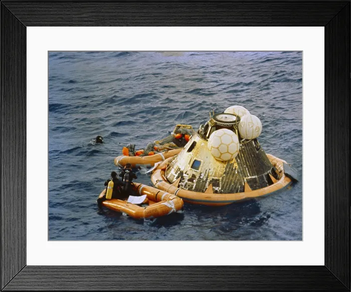 Framed Print : Apollo 11 Recovery. Behind the floating Command Module the astronauts are dressed in Biological Isolation Garments for their transfer to the quarantine trailer on the USS Hornet