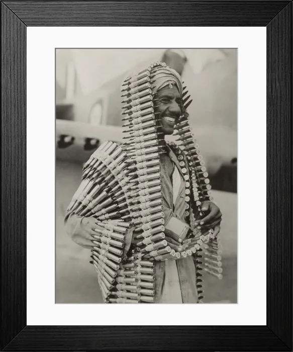 Framed Print : Libyan Arab assistant in the Royal Air Force carries ammunition for a Kittyhawk fighter. Ca. 1940-42, during World War 2. (BSLOC_2013-12_64)