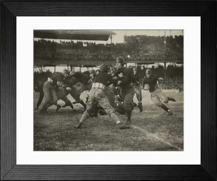 Framed Print : 1920s football action. Thousands of spectators watch from double decker stadium seats. (BSLOC_2015_17_125)