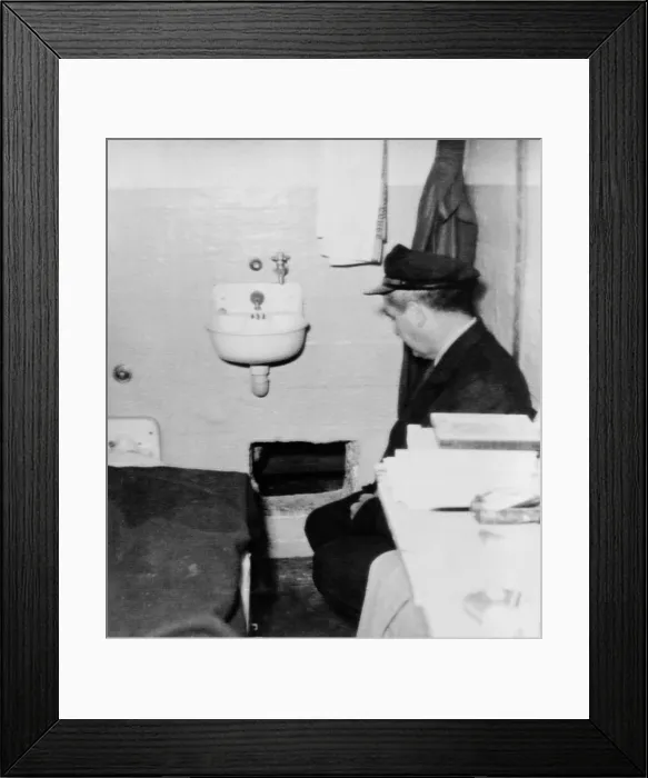 Framed Print : Prison guard sits inside the Alcatraz cell with a hole in the wall through which one of the three prisoners Frank Lee Morris and brothers John Framed Print : Prison guard sits inside the Alcatraz cell with a hole in the wall through which one of the three prisoners Frank Lee Morris and brothers John