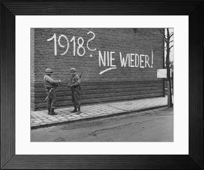 Framed Print : U.S. Ninth Army signalmen repair wires near German graffiti in the Netherlands
