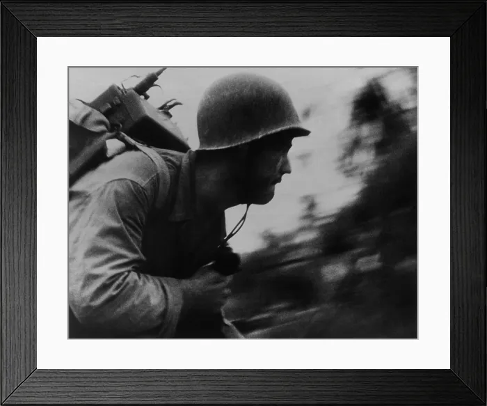 Framed Print : A Marine runs across the beach on Peleliu Island, Sept. 1944