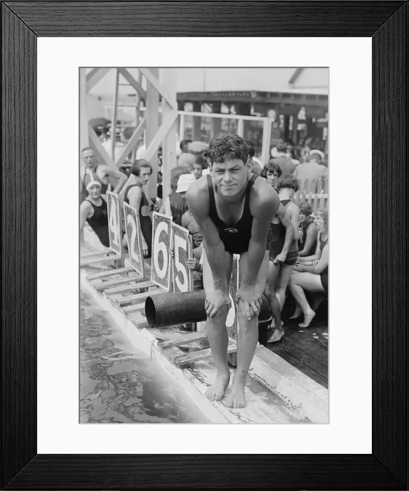 Framed Print : Johnny Weissmuller at competitive swimming event in the 1920s