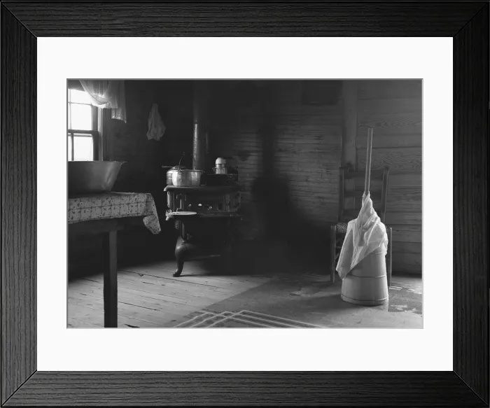 Framed Print : Kitchen in the home of tobacco sharecropper. It could be a 19th century kitchen with a cast iron cooking stove, wash basin, and a butter churn. North Carolina Framed Print : Kitchen in the home of tobacco sharecropper. It could be a 19th century kitchen with a cast iron cooking stove, wash basin, and a butter churn. North Carolina