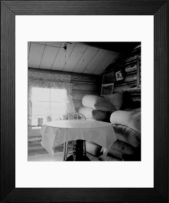 Framed Print : Interior of an Idaho farmer's two-room log home. The sacks of alfalfa seed were stored in the home while the farmers waited for a better price