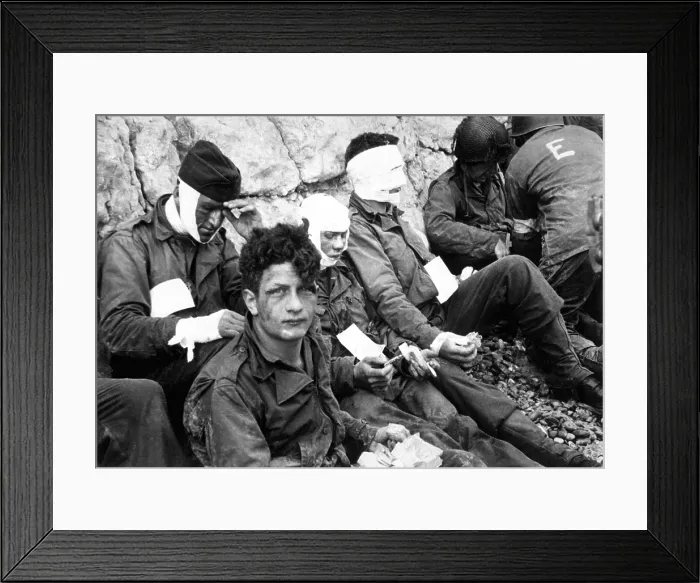 Framed Print : U.S. assault troops of the 16th Infantry Regiment, wounded on Omaha Beach, on D-Day. They wait for evacuation for further medical treatment Framed Print : U.S. assault troops of the 16th Infantry Regiment, wounded on Omaha Beach, on D-Day. They wait for evacuation for further medical treatment