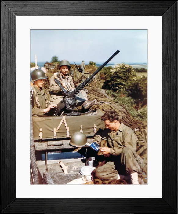 Framed Print : Three U.S. soldiers in their half-track equipped with a machine gun before the D-Day invasion. One soldiers is reading a small French textbook published for the invaders. Ca