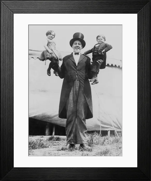 Framed Print : Johan John Aasen holding a midget, in each hand, ca. 1923 Framed Print : Johan John Aasen holding a midget, in each hand, ca. 1923