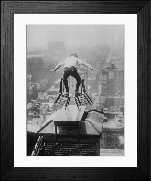 Framed Print : Human Fly John Jammie Reynolds balances precariously on two tilted chairs Framed Print : Human Fly John Jammie Reynolds balances precariously on two tilted chairs