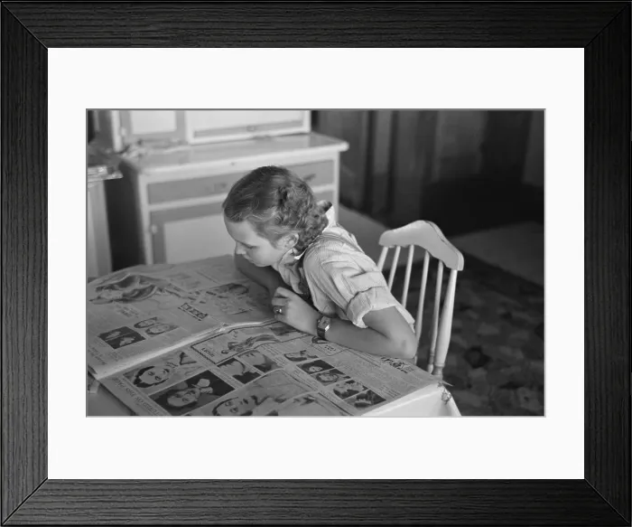 Framed Print : Royal scandal news. A farmer's daughter in Dickens, Iowa, reading a newspaper's pictorial article about Wallace Simpson and King Edward VIII's love for her. Dec. 1936