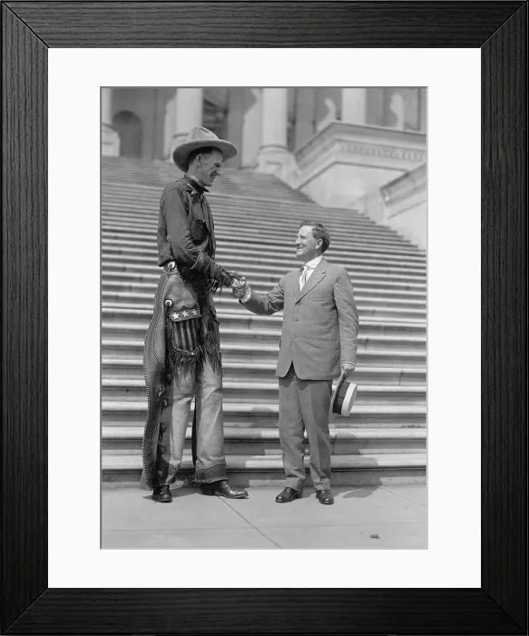 Framed Print : Ralph E. Madsen, the Tall Cowboy, shaking hands with Sen. Morris Sheppard, 1919. The Nebraska born Madsen was 7 feet 6 inches tall