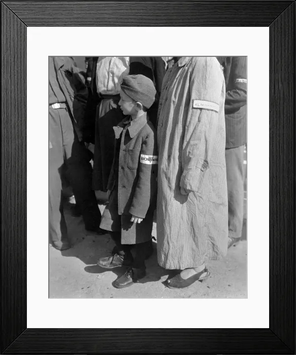 Framed Print : Six-year-old war orphan with a Buchenwald concentration camp badge on his sleeve. He waits for his name to be called for his departure to Switzerland Framed Print : Six-year-old war orphan with a Buchenwald concentration camp badge on his sleeve. He waits for his name to be called for his departure to Switzerland