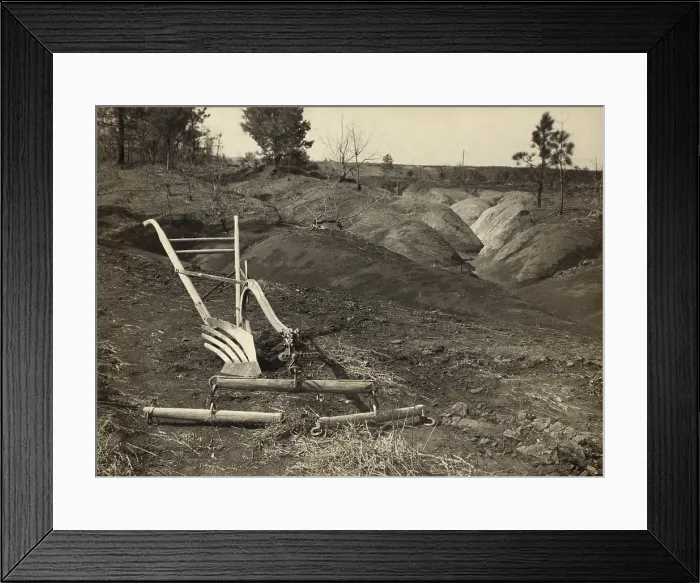 Framed Print : An idle plow on farm land adjacent to eroded land in Jackson County Alabama Framed Print : An idle plow on farm land adjacent to eroded land in Jackson County Alabama