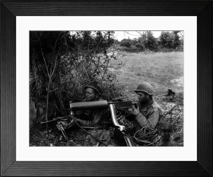 Framed Print : Two U.S. soldiers positioned in a Normandy hedgerow with a water-cooled Browning machine gun. The water inlet pipe into the front of the cooling roll is visible