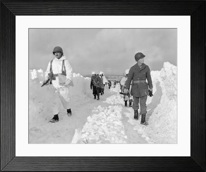 Framed Print : U.S. soldiers patrol on a path plowed through snow in the Ardennes during the Battle of the Bulge