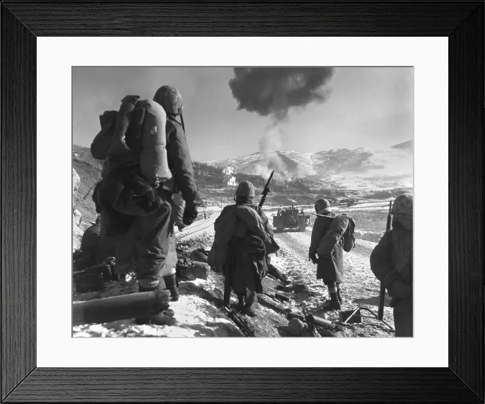 Framed Print : U.S. Marines pause at the roadblock on the way from Hagaru to Kotori in the withdrawal from the Chosin Reservoir. Marine Corsairs napalm an abandoned U.S Framed Print : U.S. Marines pause at the roadblock on the way from Hagaru to Kotori in the withdrawal from the Chosin Reservoir. Marine Corsairs napalm an abandoned U.S
