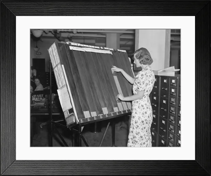 Framed Print : A worker in the Social Security Board Records Office at the visible control rack