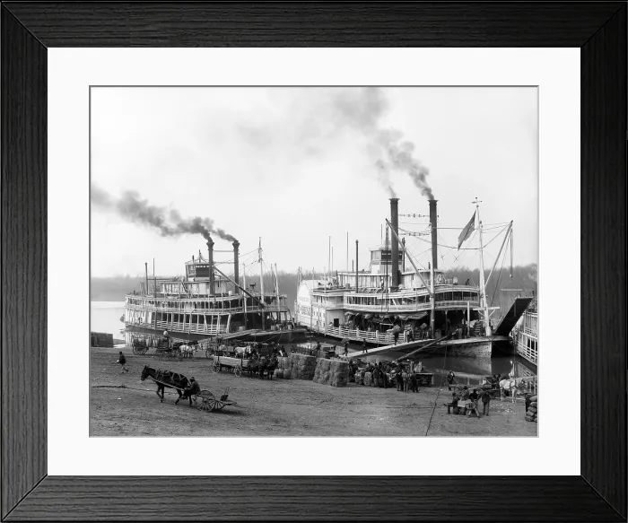 Framed Print : Riverboats on the Mississippi River receiving cargo and supplies at the Vicksburg landing. African Americans provide the hard labor of loading the boats. Ca. 1905