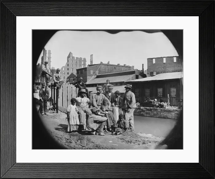 Framed Print : A newly freed African American group of men and a few children posing by a canal against the ruins of Richmond, Virginia