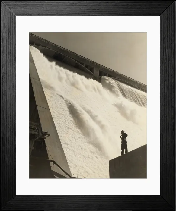 Framed Print : A workman inspecting the Grand Coulee Dam from the partially-complete wall near the east powerhouse, July 20, 1942. (BSLOC_2013_8_19)
