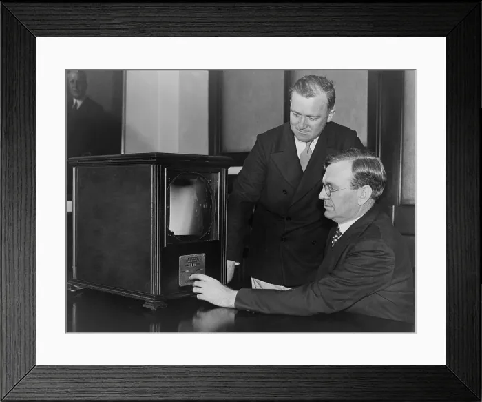 Framed Print : Labor secretary William Doak and W.W. King, examining a 1931 television receiver at the Labor Department. The magnifying screen aided viewing the small round TV image