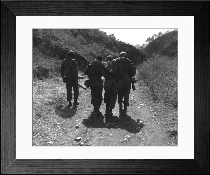 Framed Print : U.S. soldiers aid wounded man of 24th Infantry Regiment. Following a battle 10 miles south of Chorwon, in Central Korea, in the UN defense against the Chinese spring Offensive