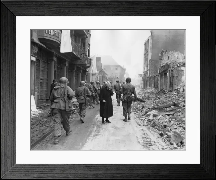 Framed Print : As infantrymen march through a German town, a shocked old woman stares at a the ruins. March-April 1945. Germany, World War 2. (BSLOC_2014_8_83) Framed Print : As infantrymen march through a German town, a shocked old woman stares at a the ruins. March-April 1945. Germany, World War 2. (BSLOC_2014_8_83)