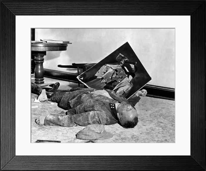 Framed Print : A dead Volksstrum general lies on the floor of city hall with a torn portrait of Hitler. He committed suicide rather than face U.S. Army occupation of Leipzig, Germany