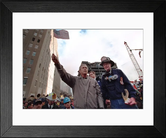 Framed Print : President George W. Bush waves an American flag after addressing recovery workers in NYC. Sept. 14, 2001. With Bush is retired New York City firefighter Bob Beckwith Framed Print : President George W. Bush waves an American flag after addressing recovery workers in NYC. Sept. 14, 2001. With Bush is retired New York City firefighter Bob Beckwith