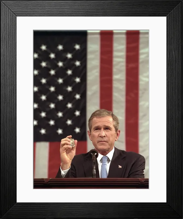 Framed Print : President George W. Bush holds the badge of a Port Authority Police officer killed on Sept. 11, 2001. Bush 43 said, I will carry this
