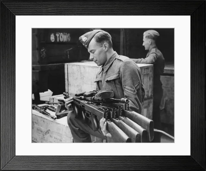 Framed Print : Tommy guns arriving in England from the U.S. Lend-Lease are unpacked by an ordnance corporal. Ca. 1941-1943. World War 2. (BSLOC_2014_10_151)